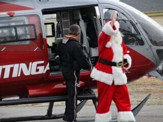 Santa flies into Toys for Tots