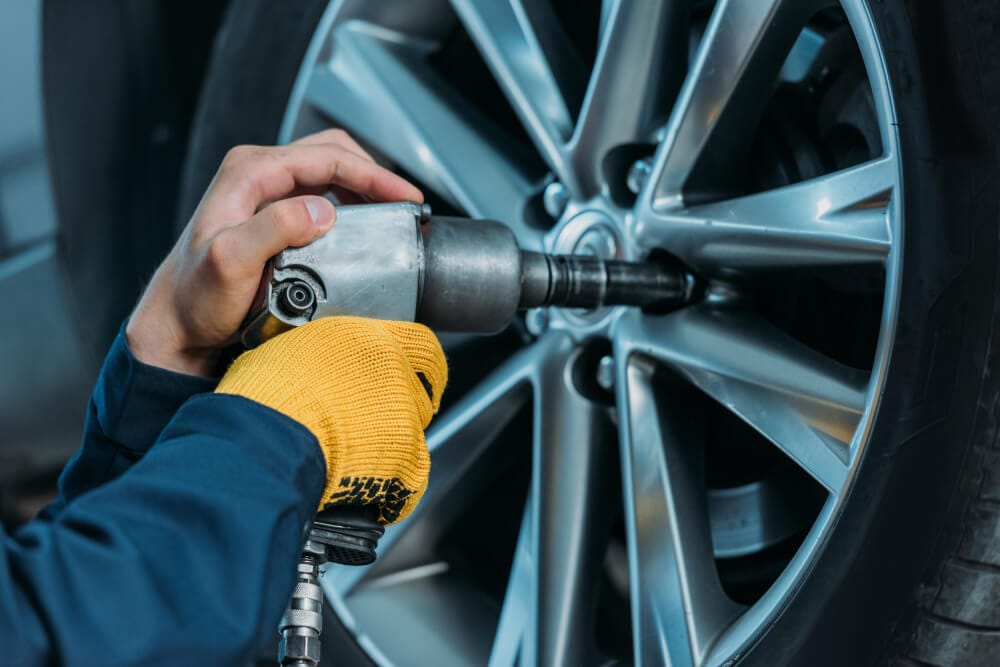 Auto Mechanic working on a car wheel